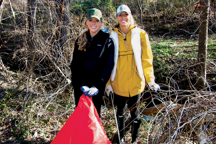 Two students from professor Robin Vaughan Hirshorn’s Environmental Biology class pick up trash at the Sligo Creek site.
