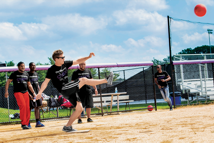 A student kicks a high fly ball in the Dean’s Cup annual kickball game.