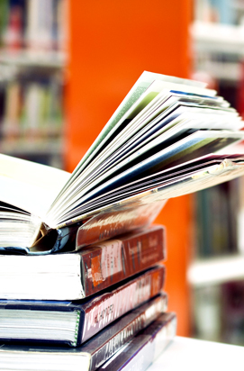 Stack of books on a library table.