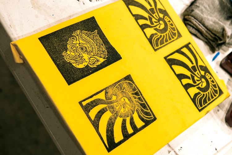 Open studios were held to print 10" x 12" flags using five pre-carved blocks, a variety of solid-color fabric, special printing jigs, and black oil-based inks.