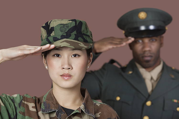 Close-up portrait of young female US Marine Corps soldier with male officer saluting over brown background.