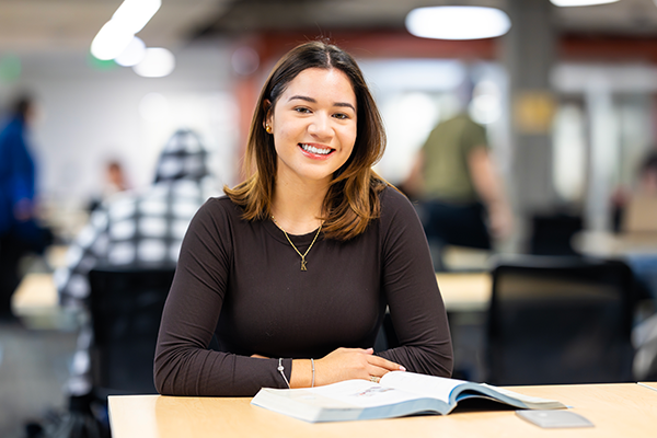 Raptor Rep Kenia posing for a photo in a library