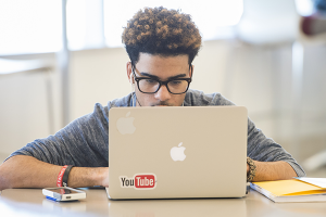 Student working on a MAC Laptop